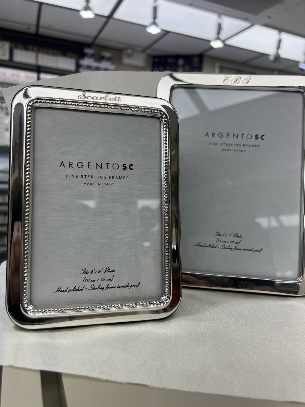 Several engraved silver photo frames prepared as gifts
