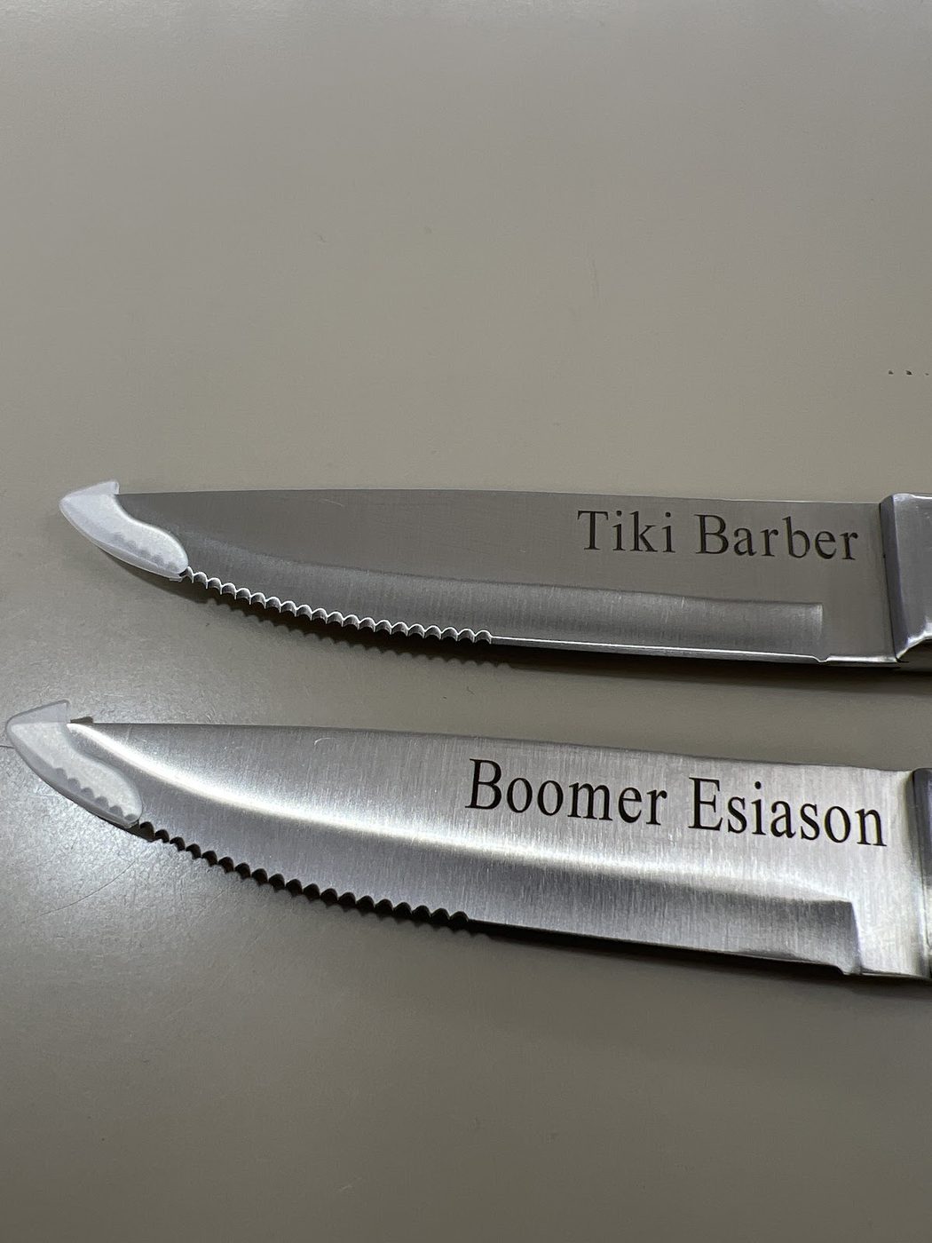 Two stainless steak knives laser engraved with the names Tiki Barber and Boomer Esiason