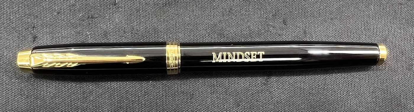 Black and gold pen engraved along the barrel