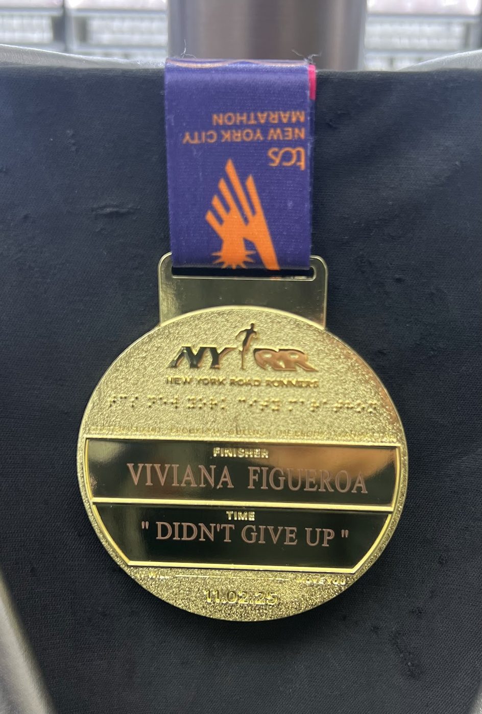 Half marathon medal engraved with a runner name and the words Didn't Give Up