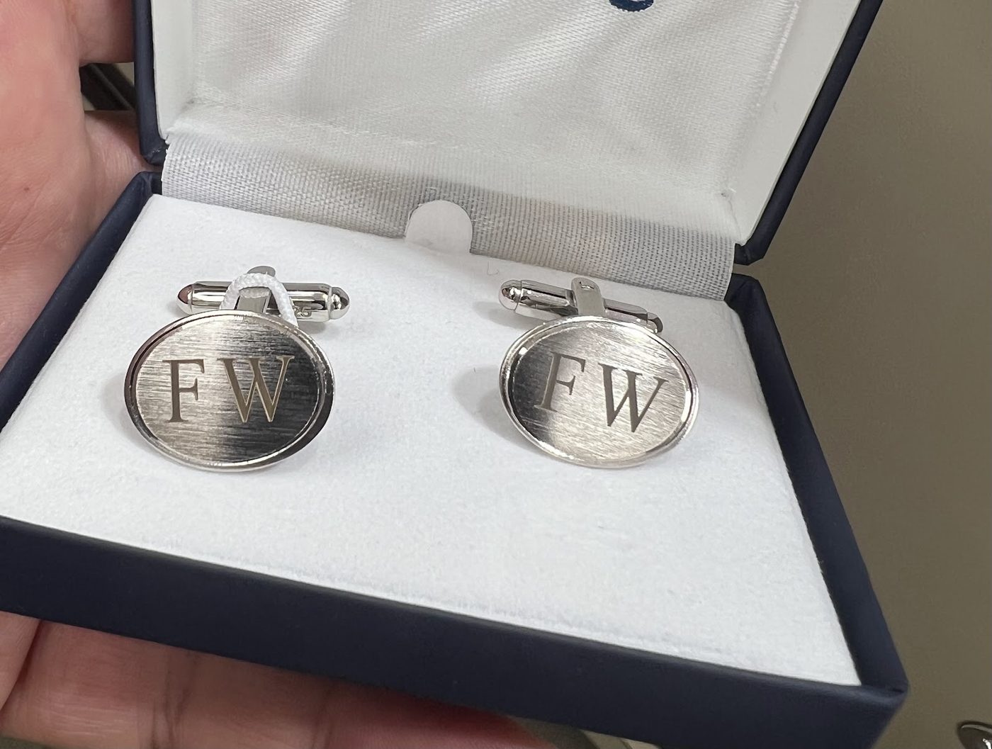 Pair of silver cufflinks engraved with initials in a presentation box