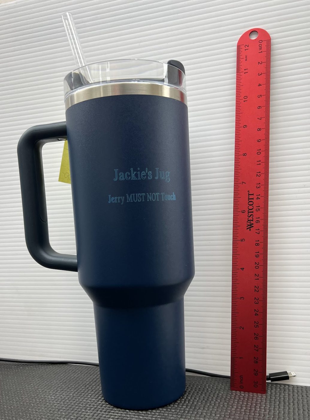 Navy insulated travel tumbler engraved with a name