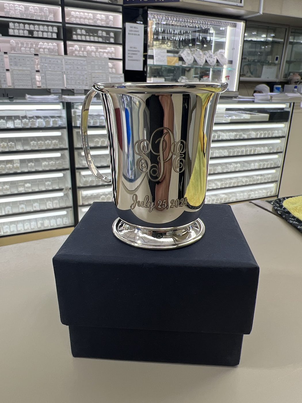 Polished silver julep cup on a black display box