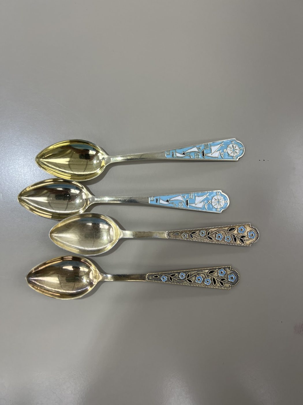 A set of decorative silver spoons with engraved handles