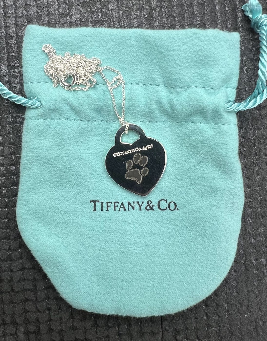Engraved Tiffany and Company heart tag with its blue drawstring pouch