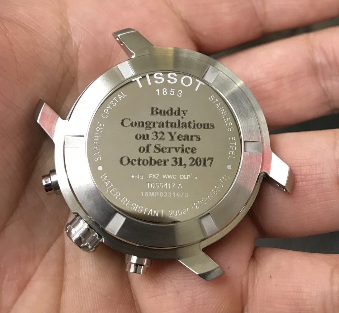 Tissot chronograph case back engraved to congratulate an employee on 32 years of service